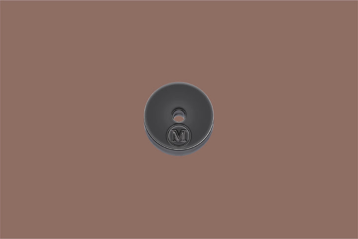 Dark gray incense holder with a logo on a brown background