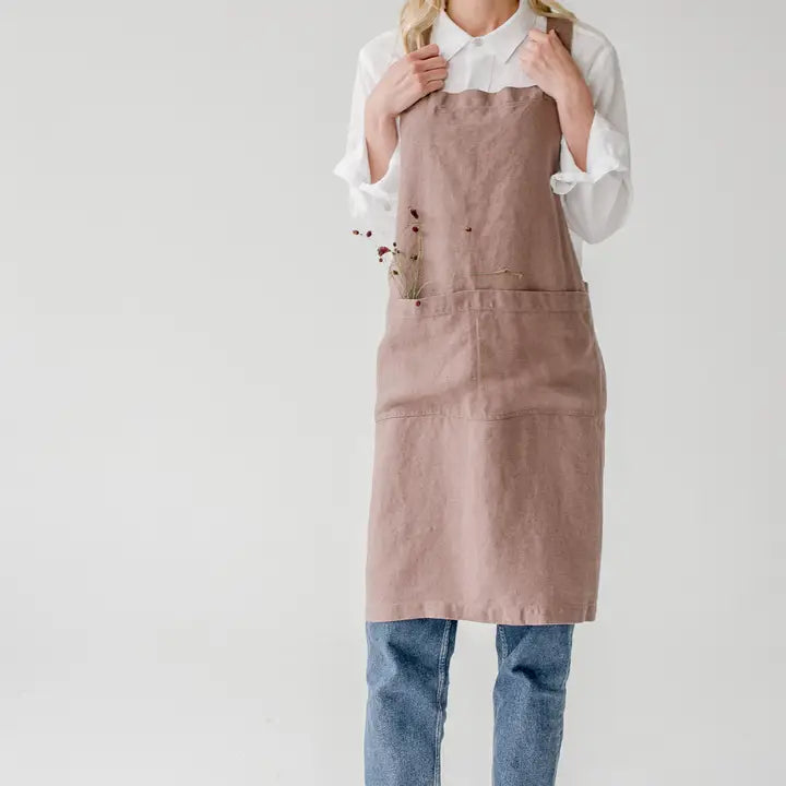 Person wearing a pink apron on a white background