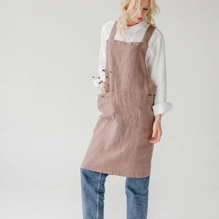 Person wearing a pink apron on a white background