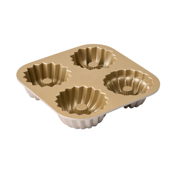 Gold metal bundt pan with four cupcake molds on a white background