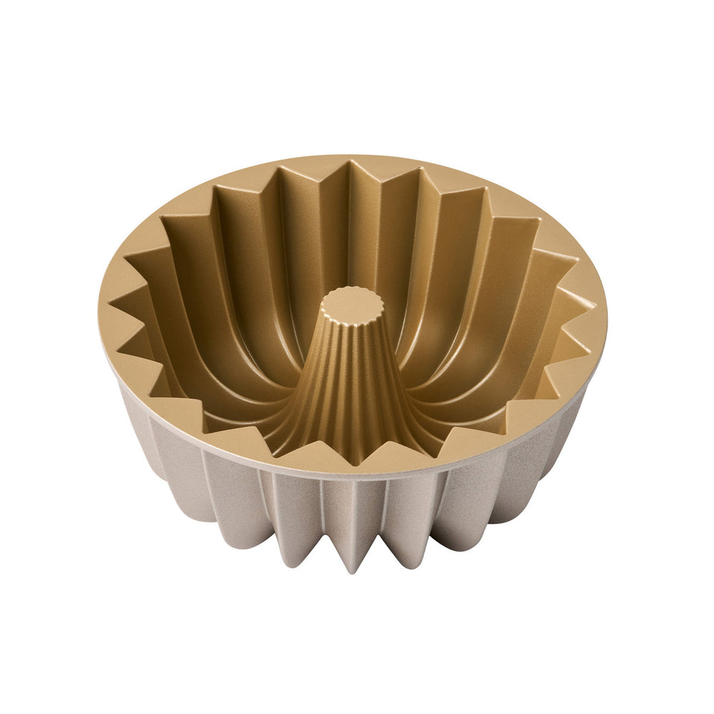 Gold and beige bundt cake mold on a white background