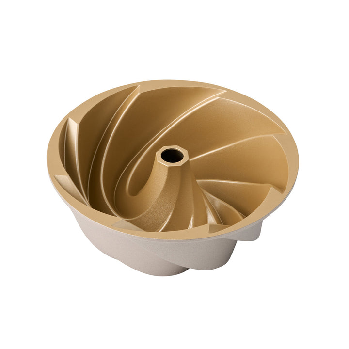 Gold and beige bundt cake mold on a white background