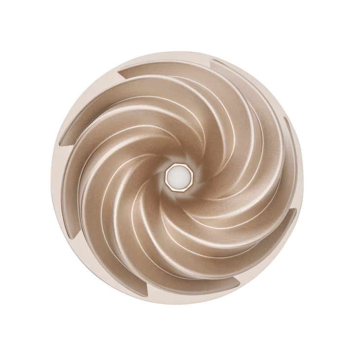 Gold spiral cake tin on a white background
