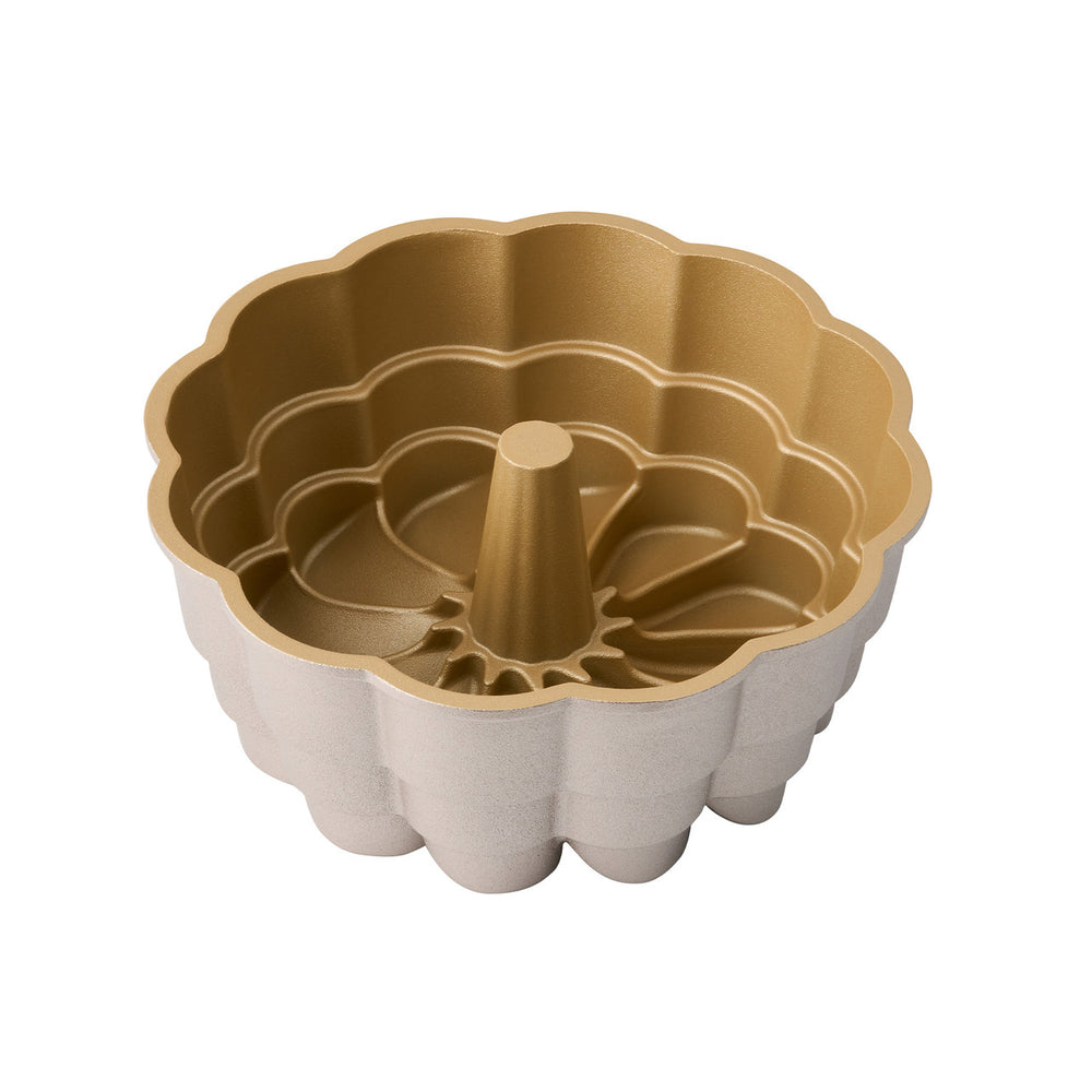 Gold Bundt cake pan on a white background