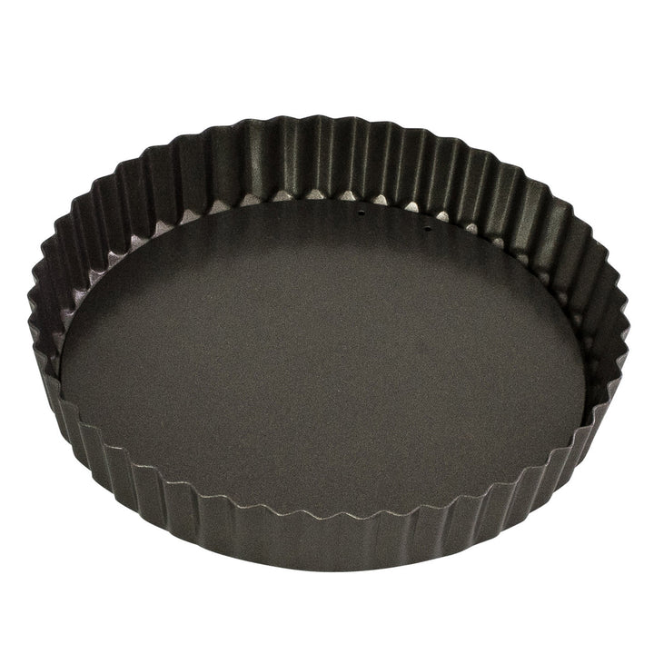 Black fluted tart pan on a white background