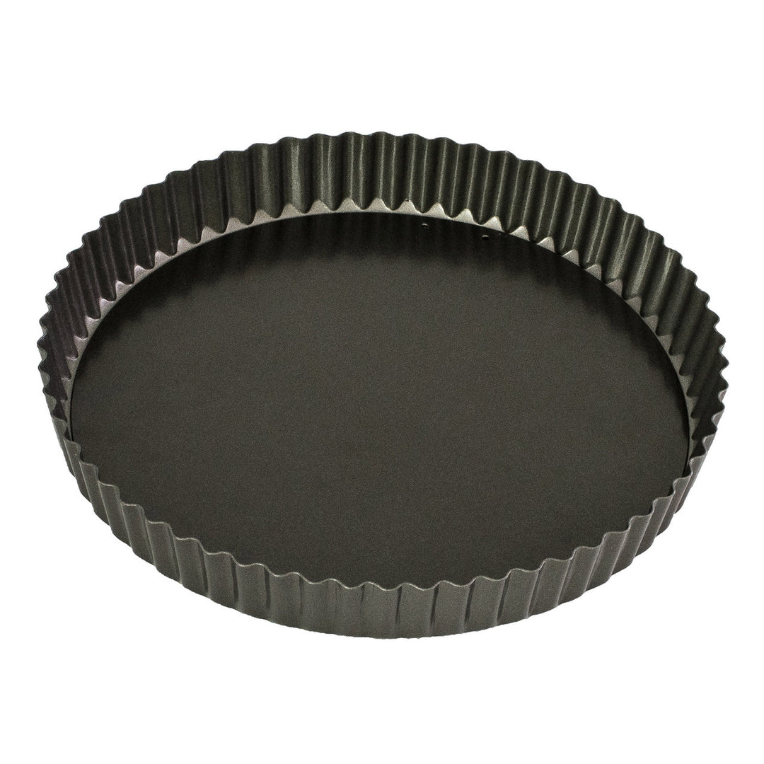 Black fluted tart pan on a white background