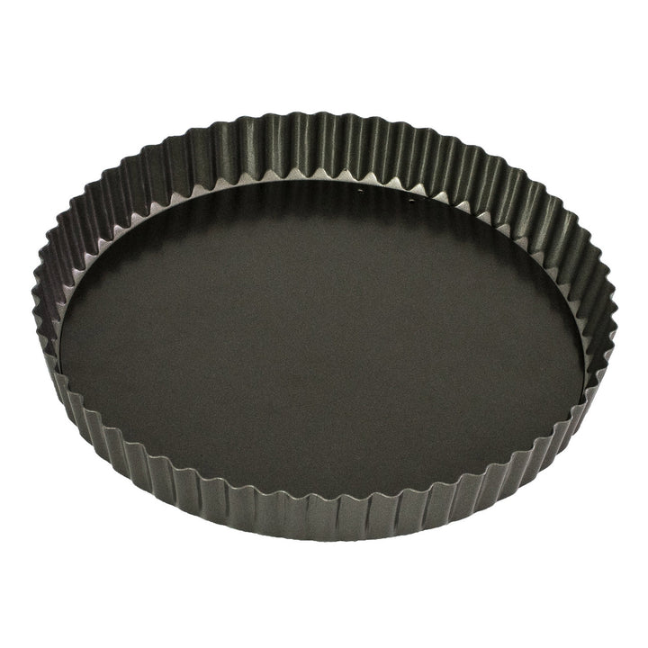 Black fluted tart pan on a white background