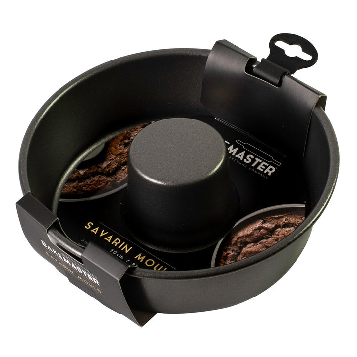 Black Savarin mold with baked goods  on the packaging on a white background