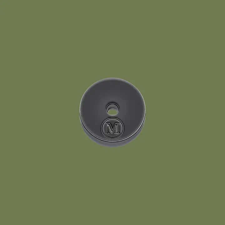 Black incense holder with a logo on a green background