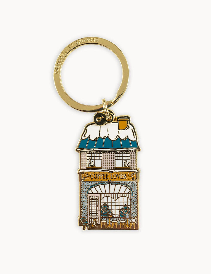 Keychain with a building design featuring a sign that reads 'Coffee Lover' on a white background.