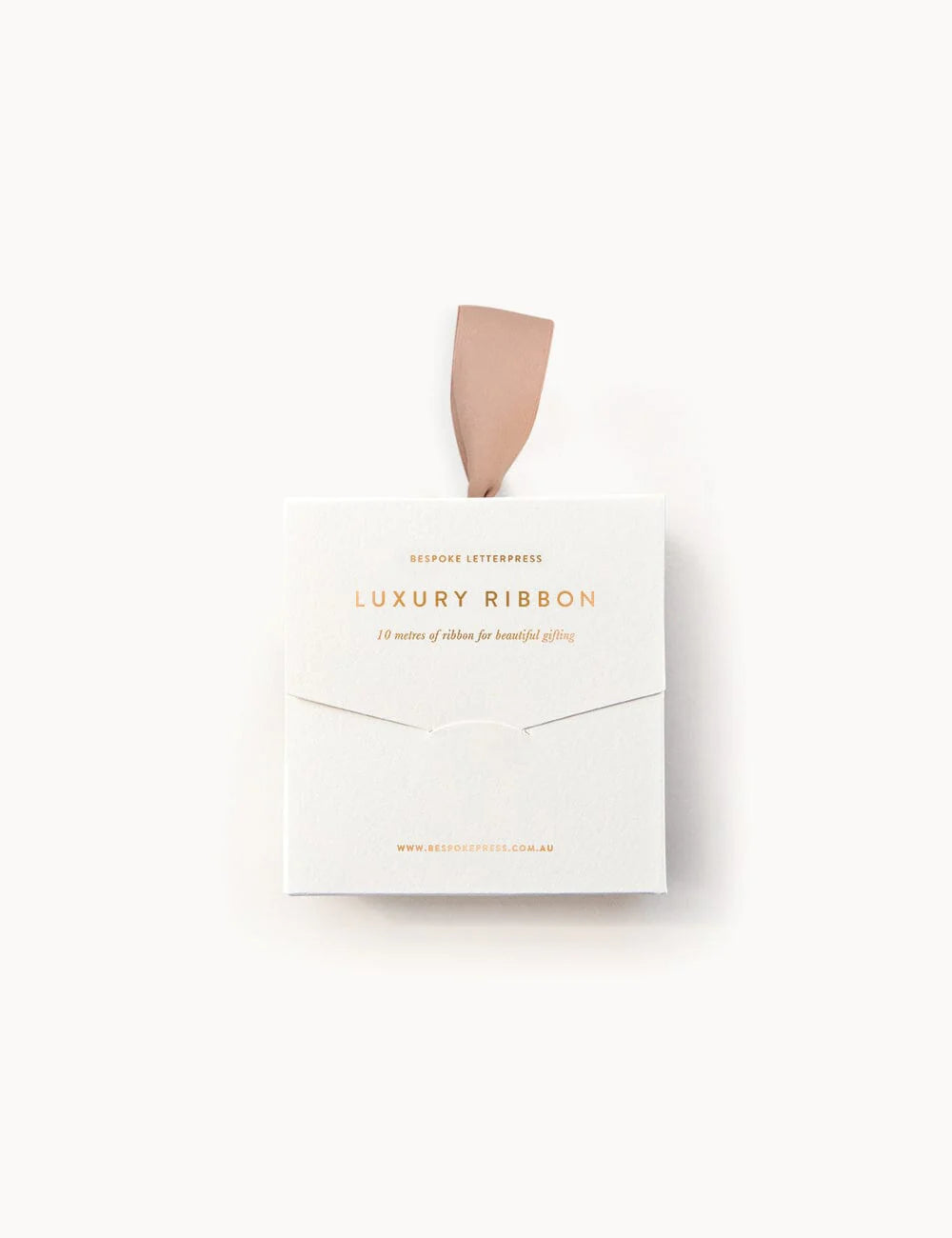 Box of luxury ribbon with a beige ribbon on a white background