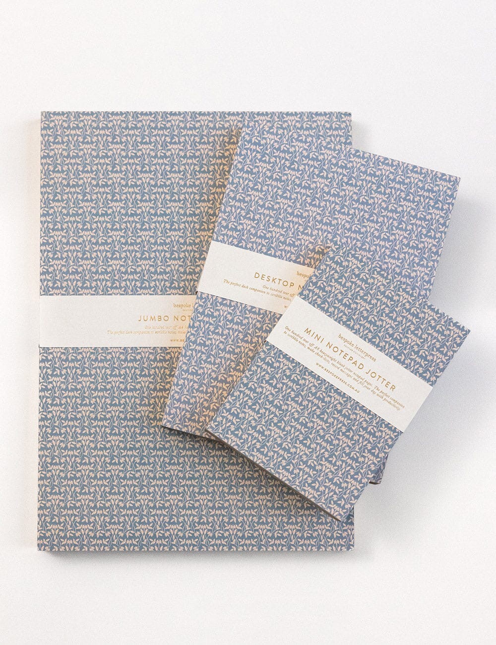 Set of notebooks with blue floral pattern on a white background