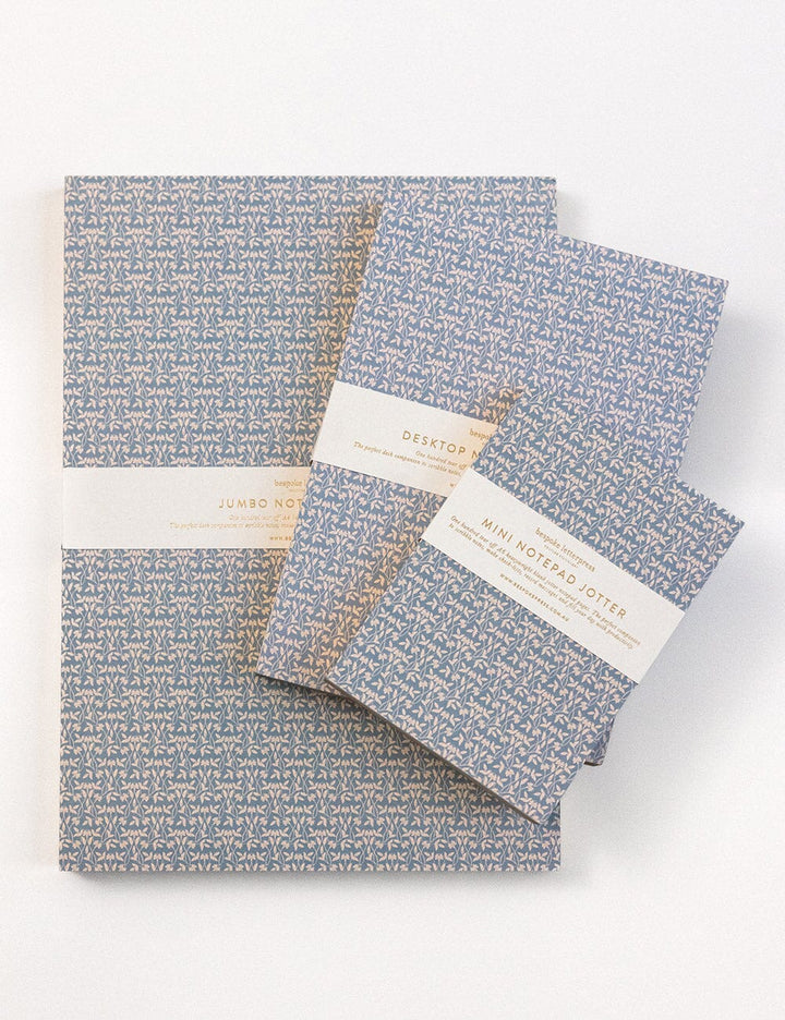 Set of notebooks with blue floral pattern on a white background