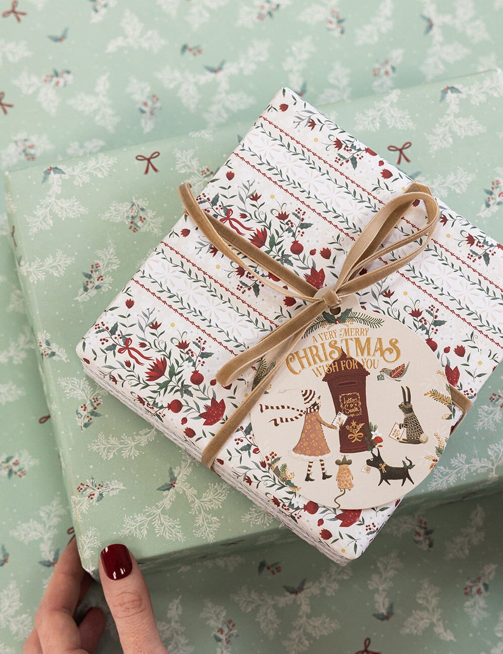 Gift wrapped in festive paper with a decorative ribbon on a matching background