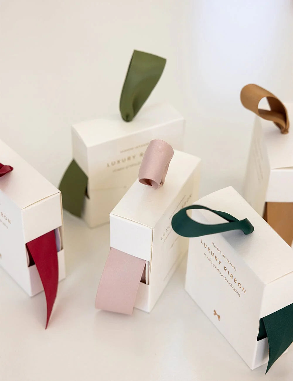 White packaging with ribbons on a light background