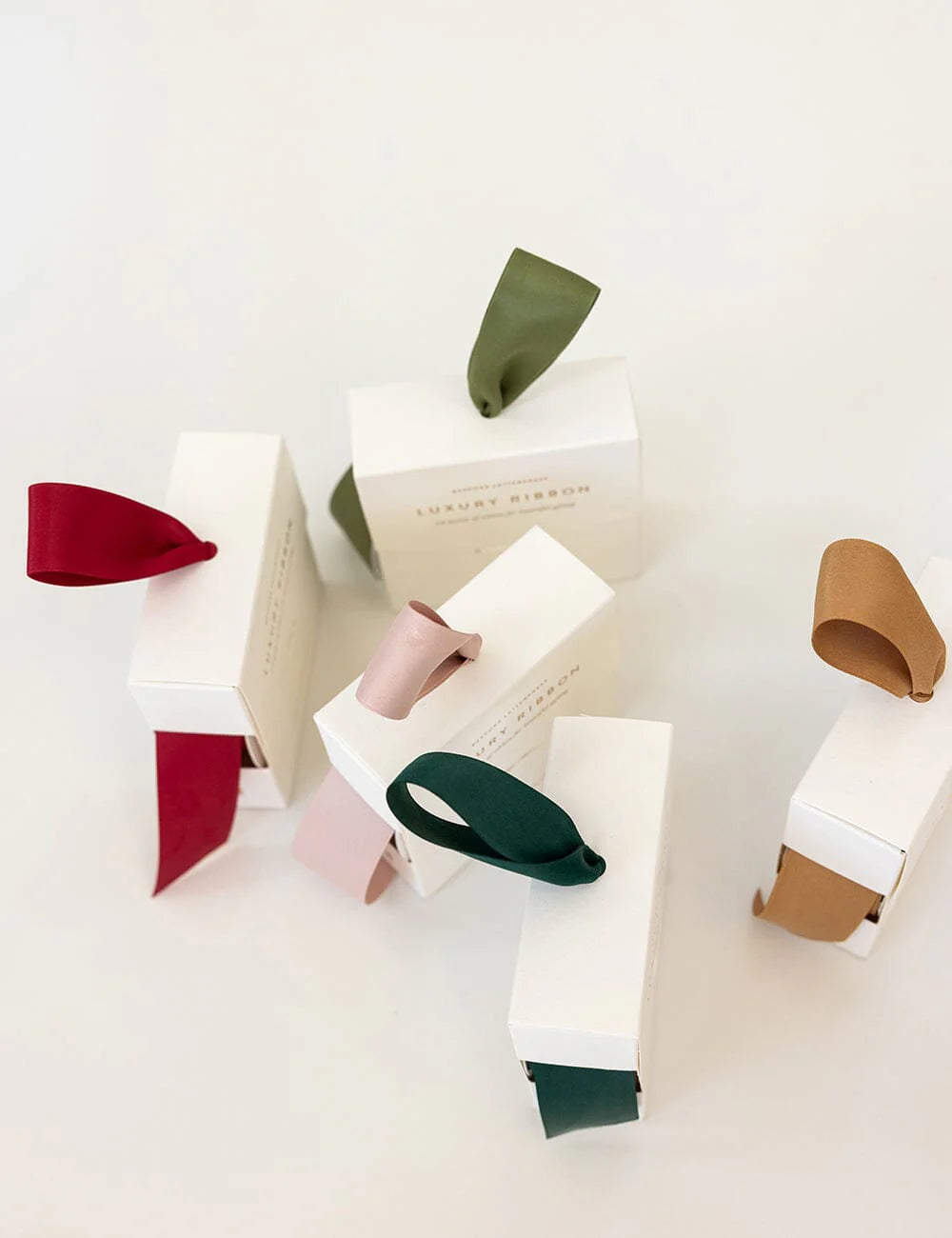 Colorful ribbons in a white box on a white background