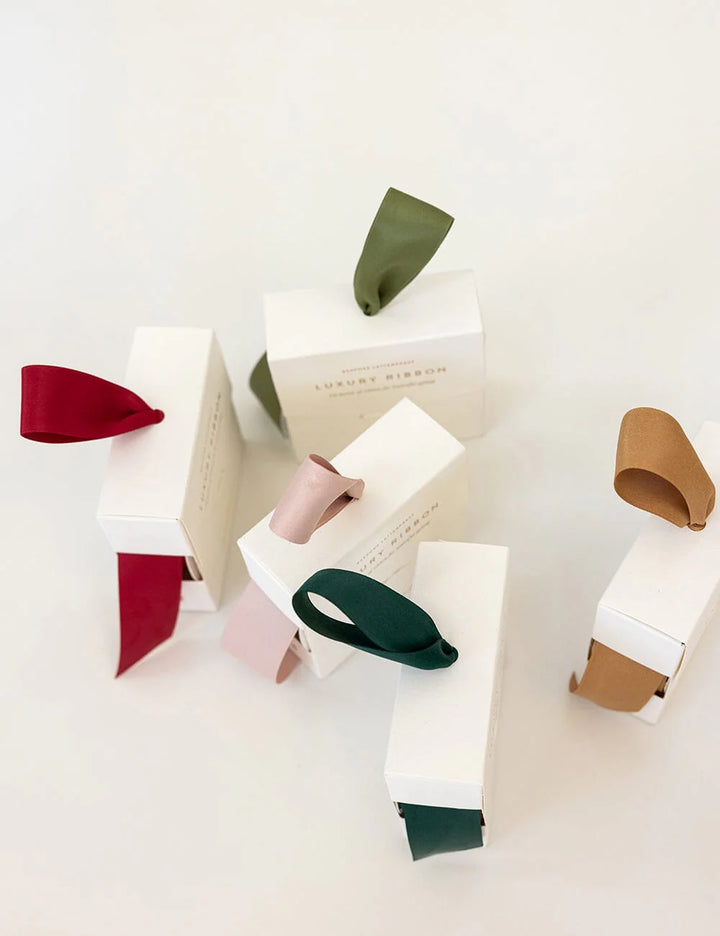 Colorful ribbons in a white box on a white background