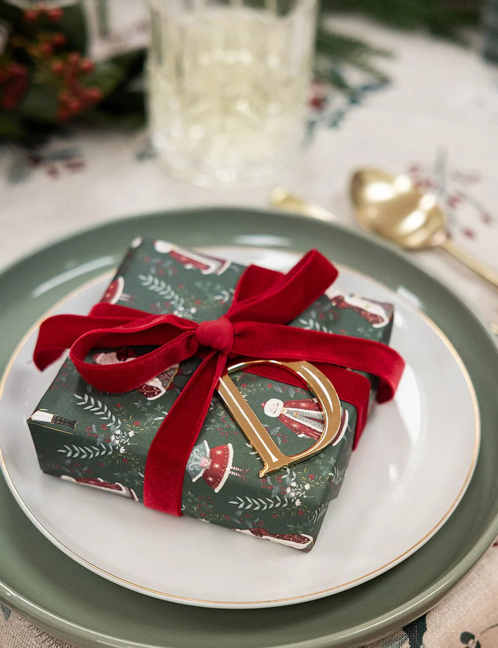 Gift box with red ribbon on a plate with a festive background