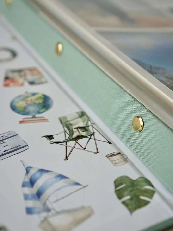Collection of decorative stickers with a chair, sailboat, and leaf on a light green background.