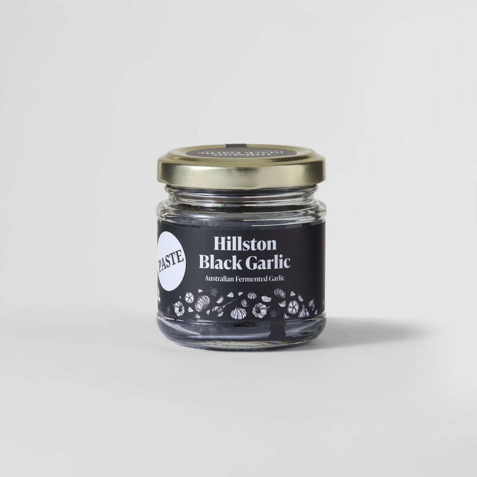Jar of Hillston Black Garlic on a light gray background