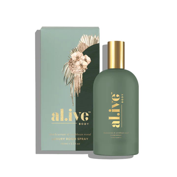 Green room spray bottle with gold cap and 'alive' branding next to its packaging on a white background