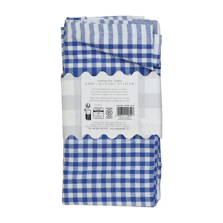 Packaged blue and white checkered paper towels on a white background