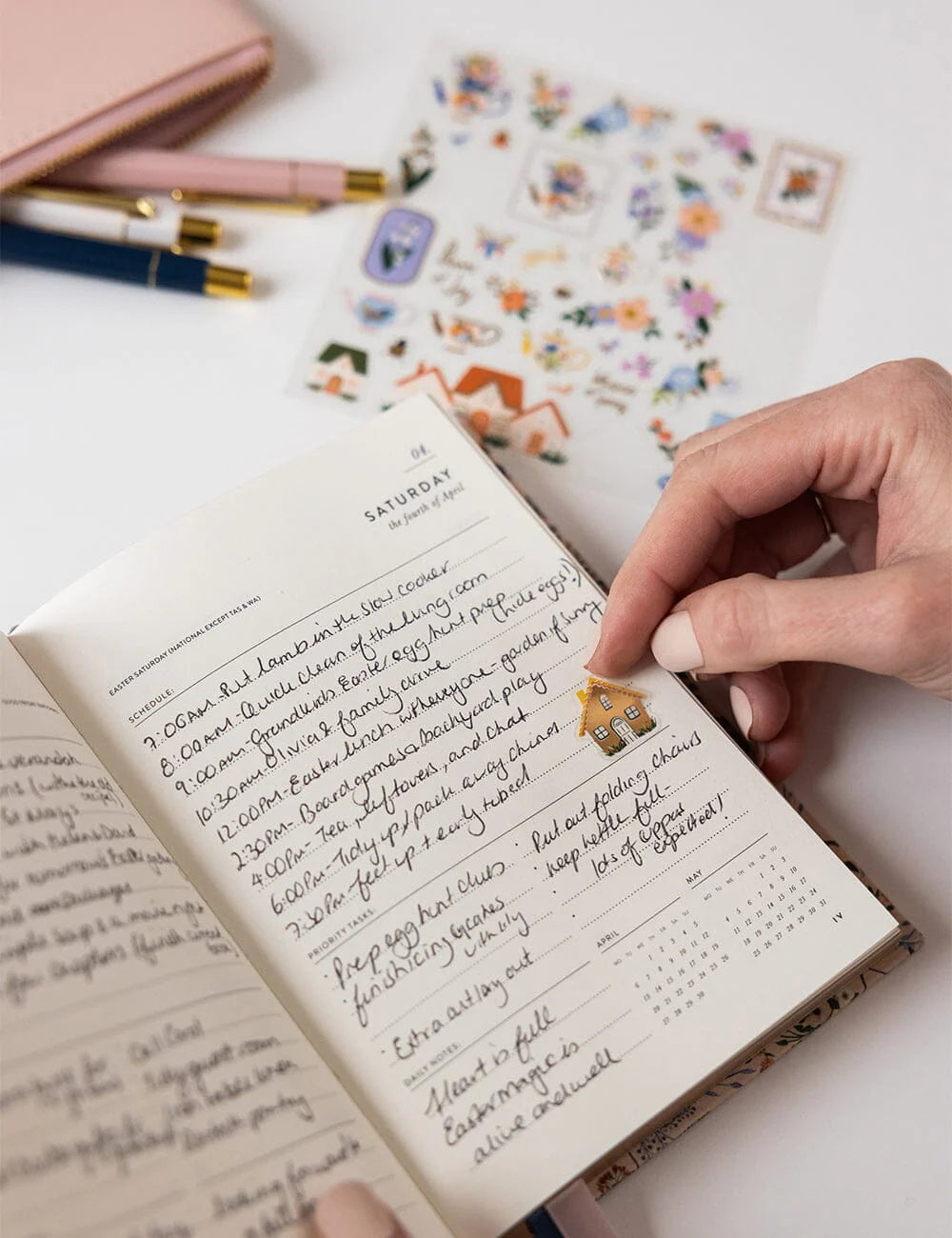 Handwritten journal entry with decorative stickers on a white surface