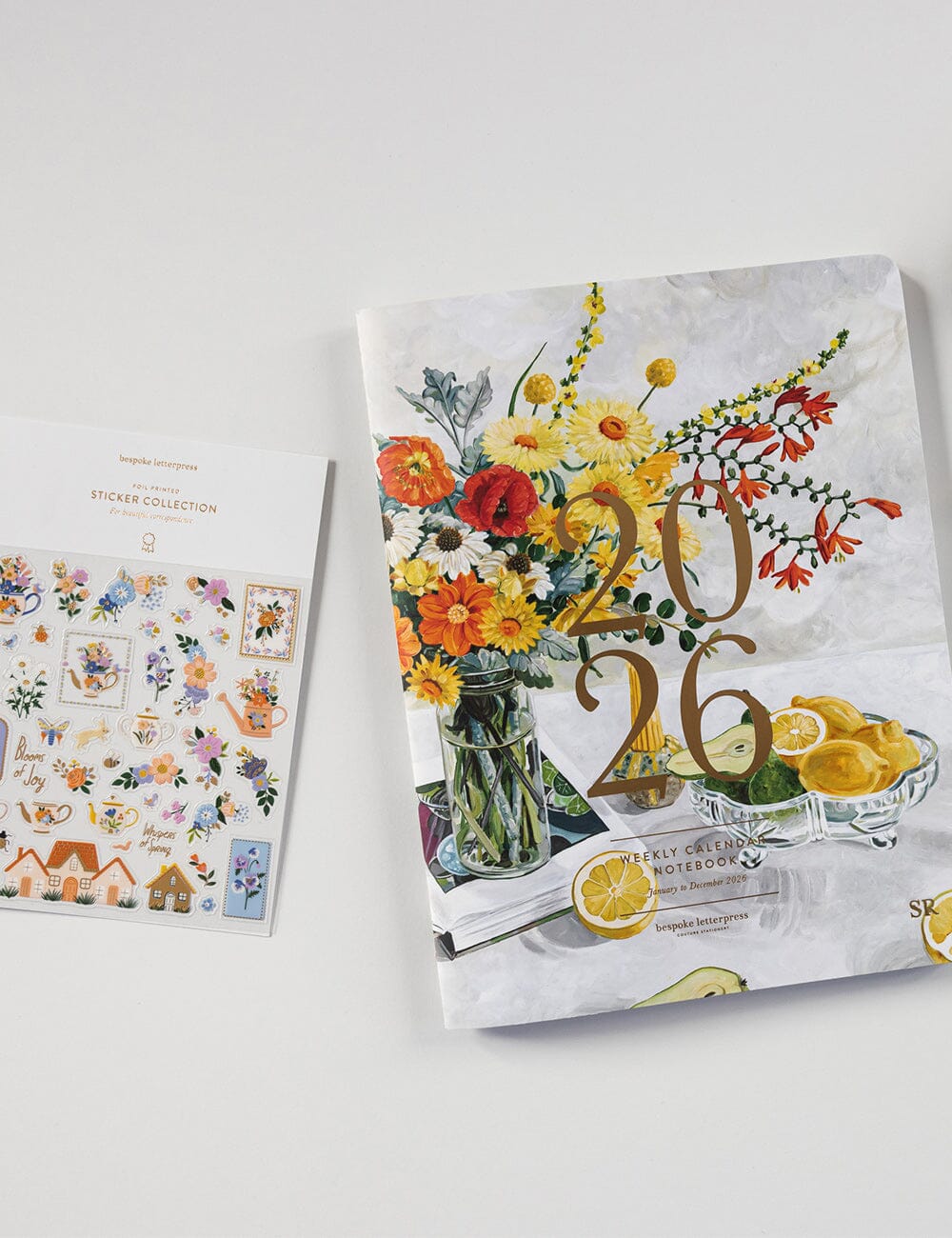 Calendar with floral design and '2026' text on a white surface