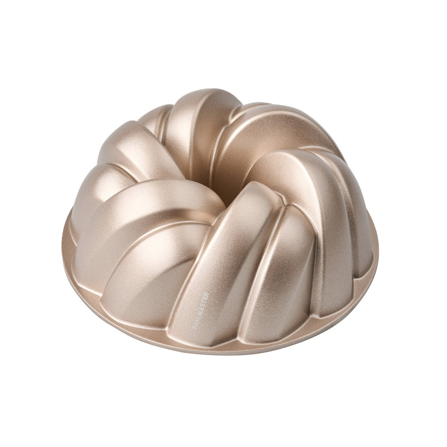 Bronze bundt cake mold on a white background