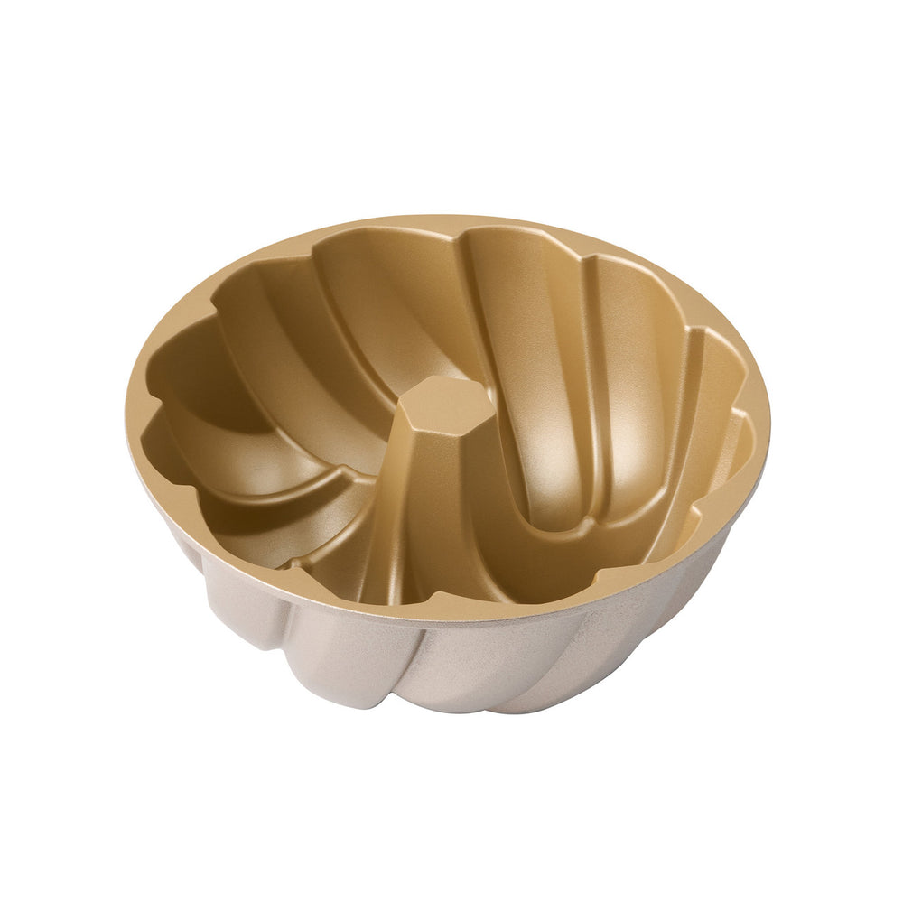 Gold and beige bundt cake mold on a white background