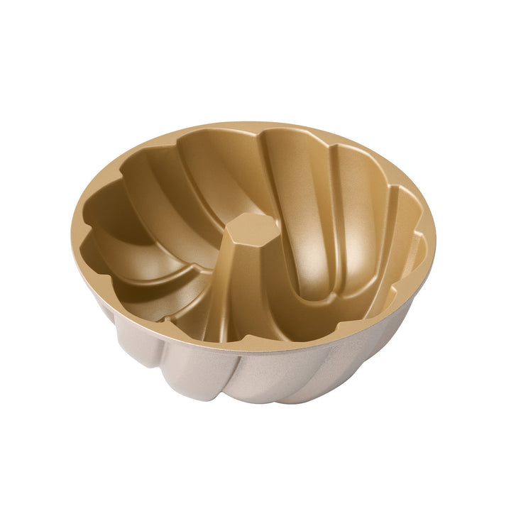 Gold and beige bundt cake mold on a white background