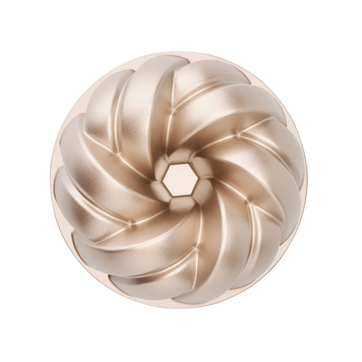 Bronze bundt cake mold on a white background