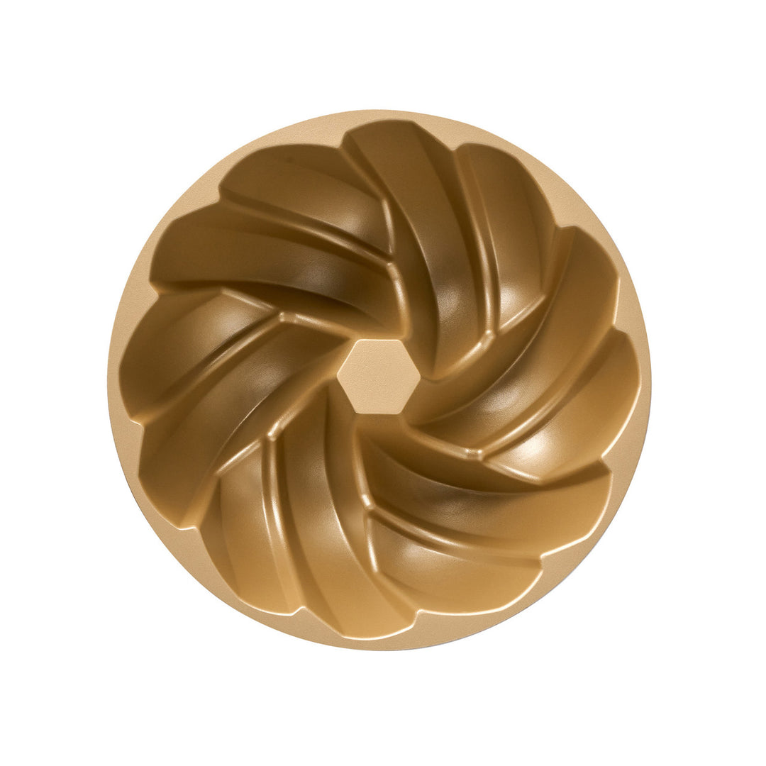 Bronze bundt cake mold on a white background