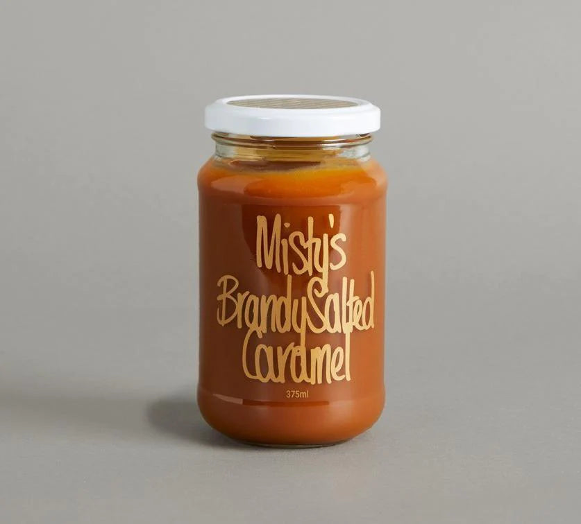 Jar of Misty's Brandy Salted Caramel on a gray background
