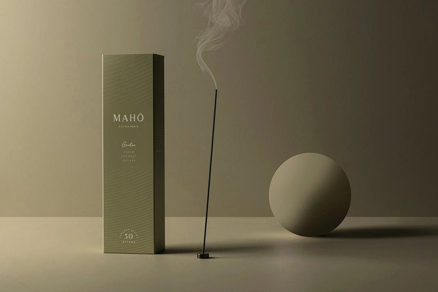 Maho incense box with a smoking incense stick on a neutral background
