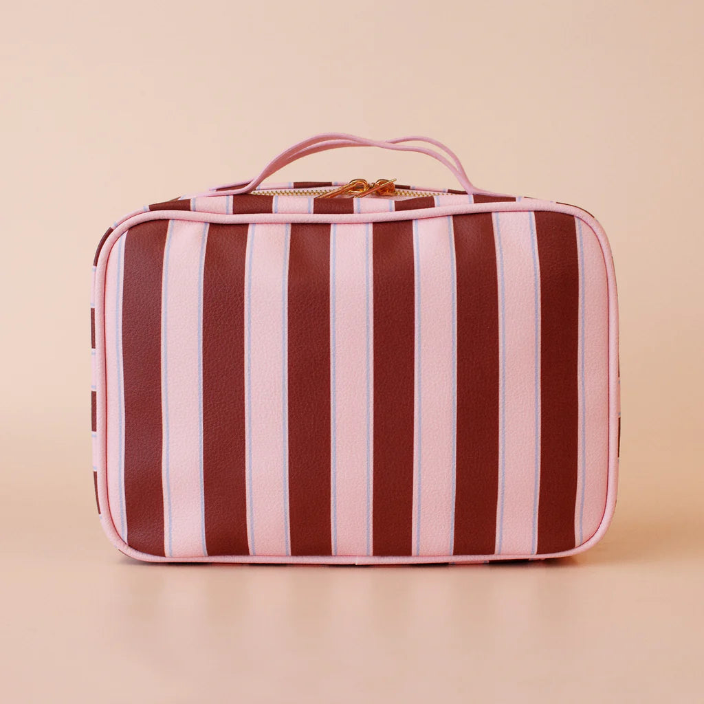 Striped travel case with pink and brown stripes on a beige background