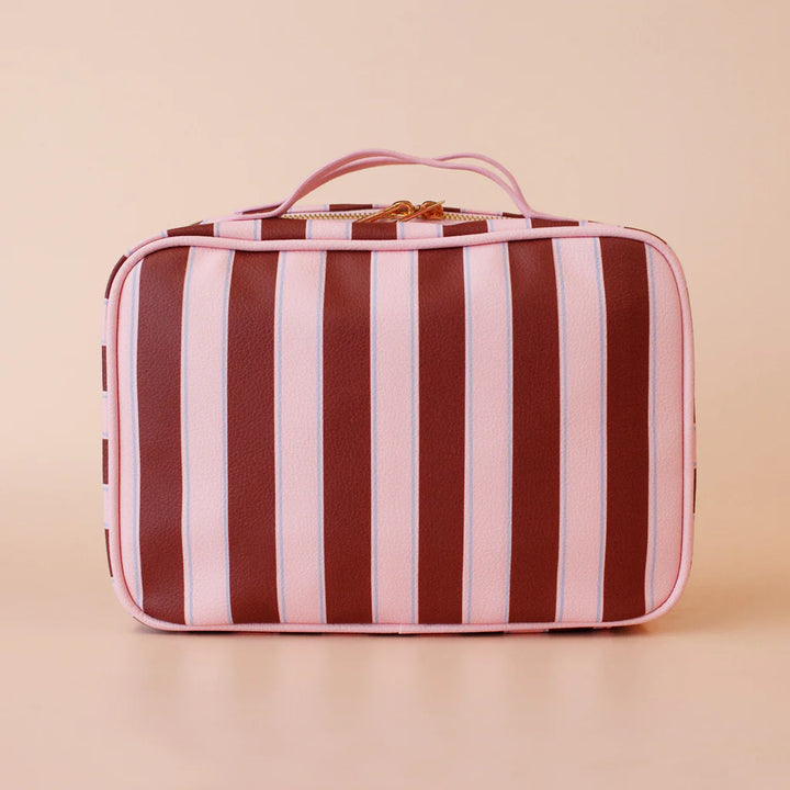 Striped travel case with pink and brown stripes on a beige background