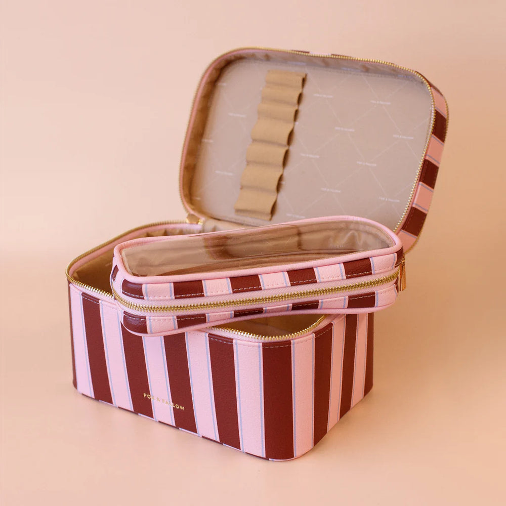 Striped fabric storage case with open lid on a beige background