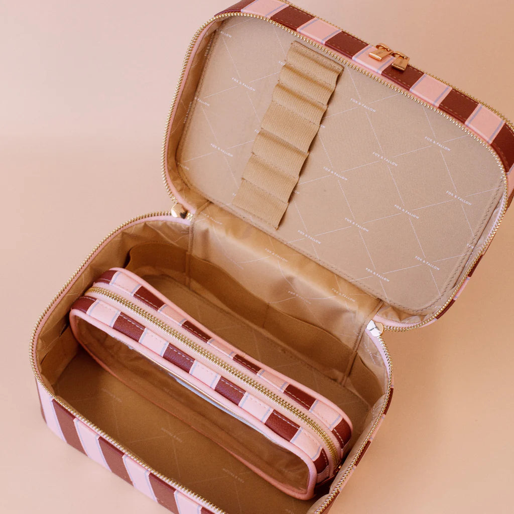 Open jewelry case with checkered design on a beige background