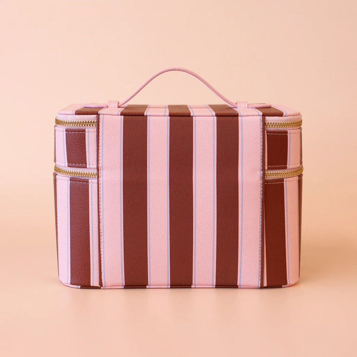 Striped vanity case with a handle on a beige background
