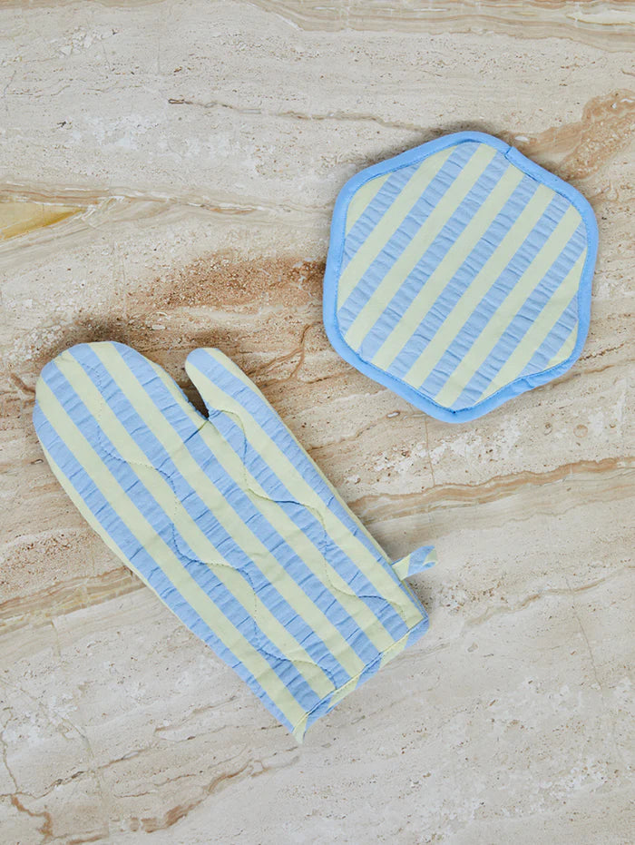 Striped oven mitt and pot holder on a marble surface