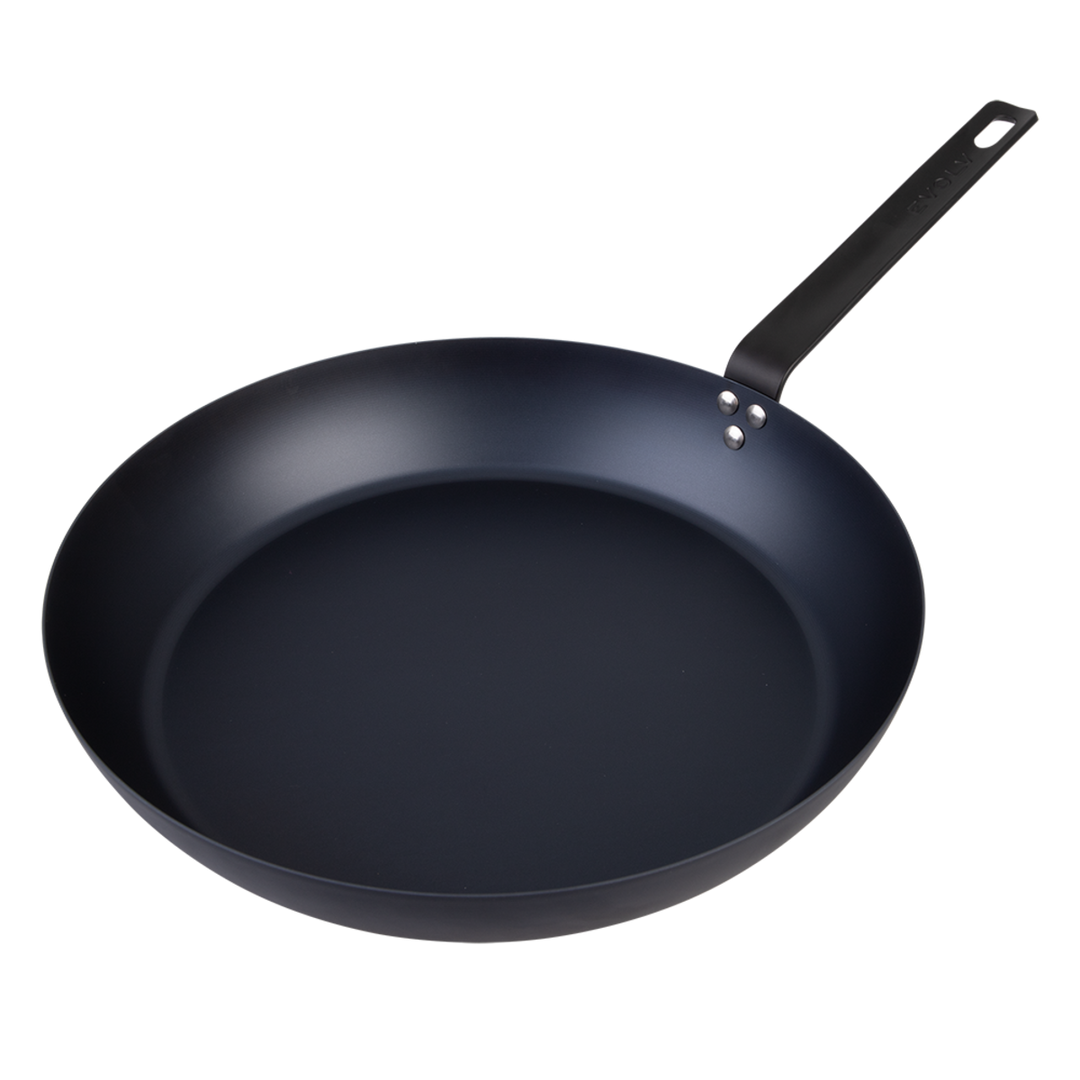 Black carbon steel frying pan on a white background