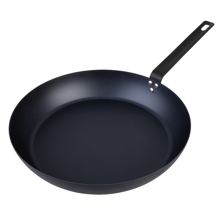 Black carbon steel frying pan on a white background