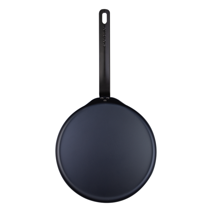 Black carbon steel pancake pan on a white background