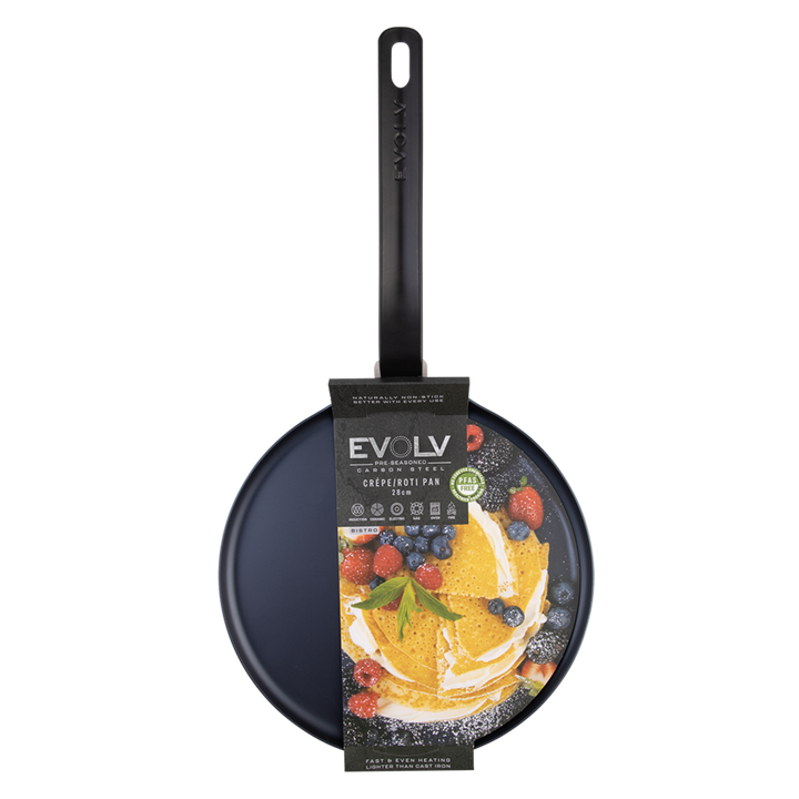 Black carbon steel pancake pan with a decorative label on a white background