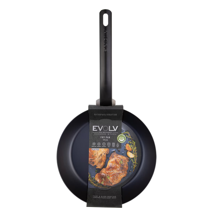 Black carbon steel frying pan with Evolv branding and a label showing food on a white background