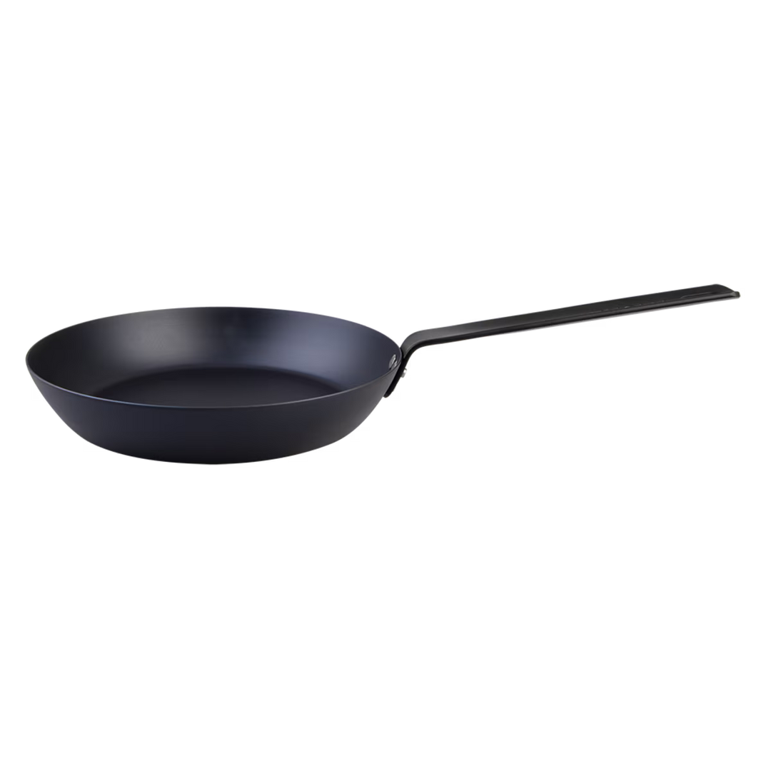 Black carbon steel frying pan on a white background