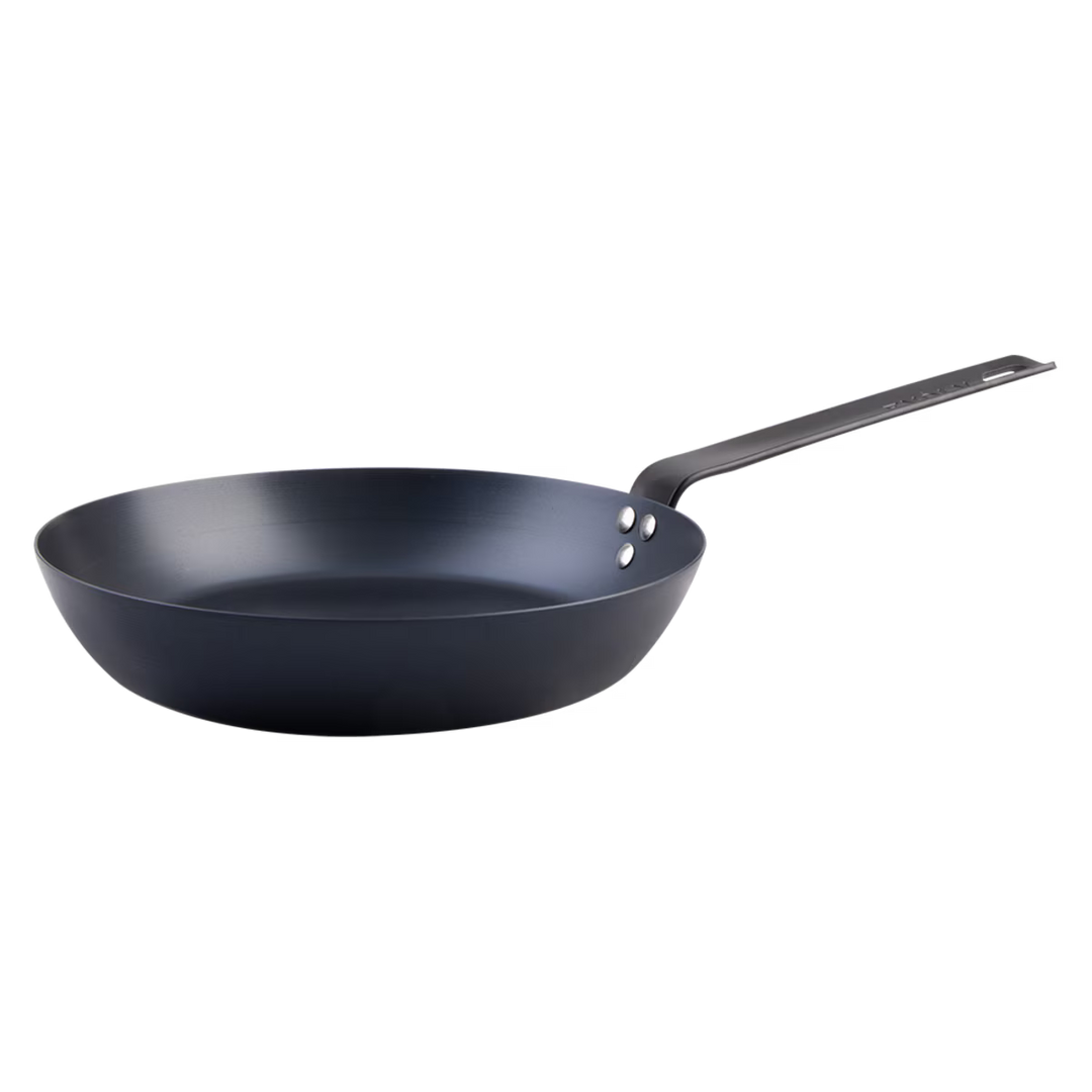 Black carbon steel frying pan on a white background