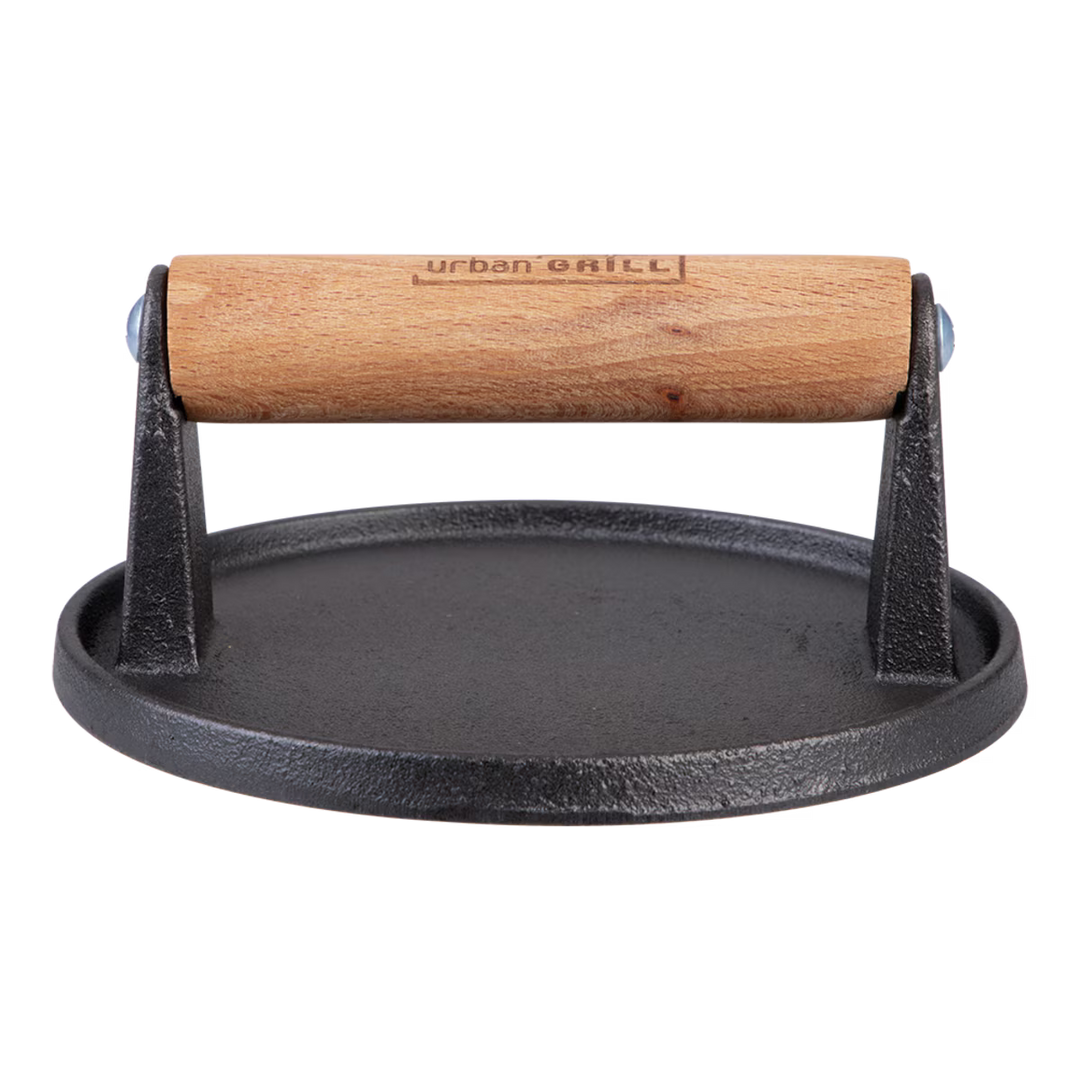 Black cast iron burger press with wooden handle on a white background