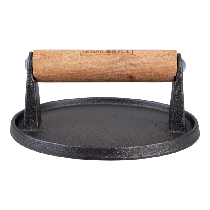 Black cast iron burger press with wooden handle on a white background